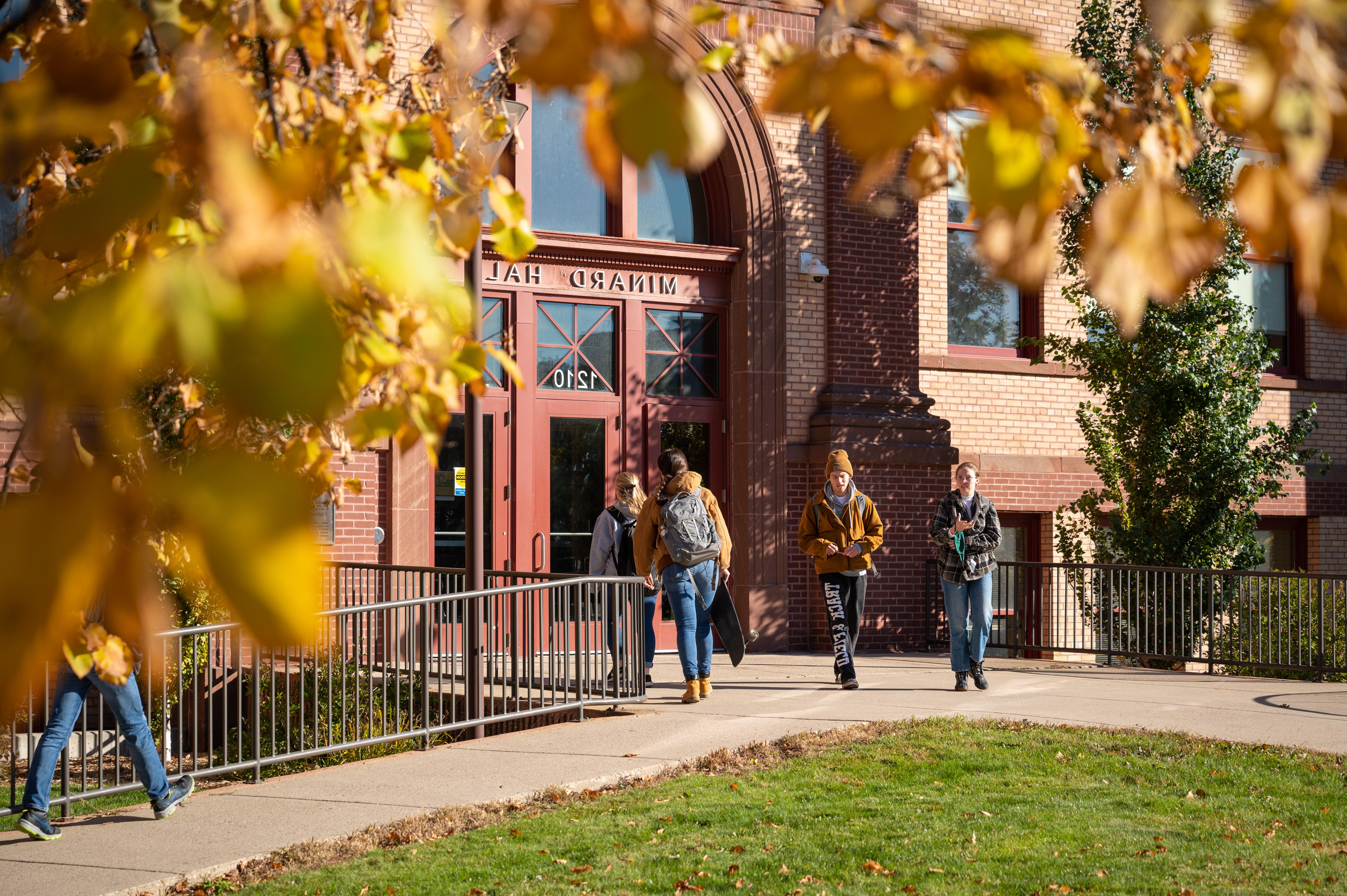 Students leaving academic building in fall